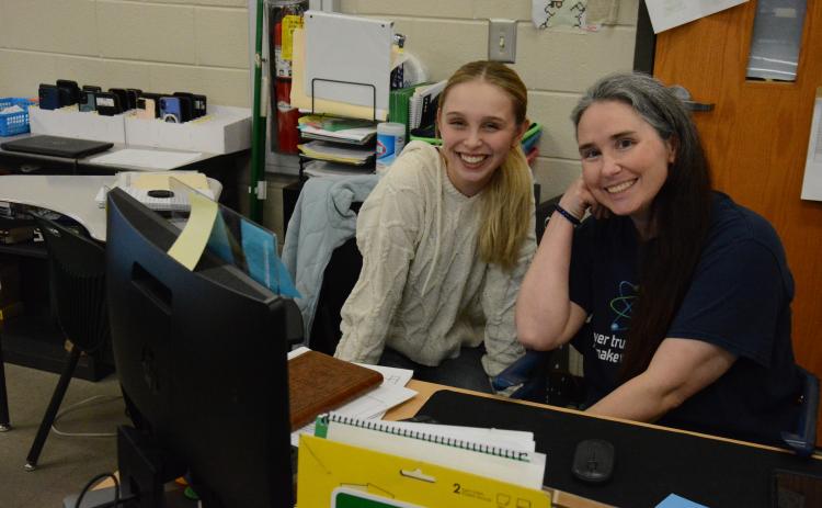 FCHS teacher Brandie Thomas consults with student Charlize Smith during her physical science class. Thomes is one of about one million Americans diagnosed with multiple sclerosis (MS). She is sponsoring a fundraising Walk for MS on March 14 at Ed Bryant Stadium. The money raised will go to the National MS Society, which funds research to find a cure. (Photo by Charlie Eavenson)