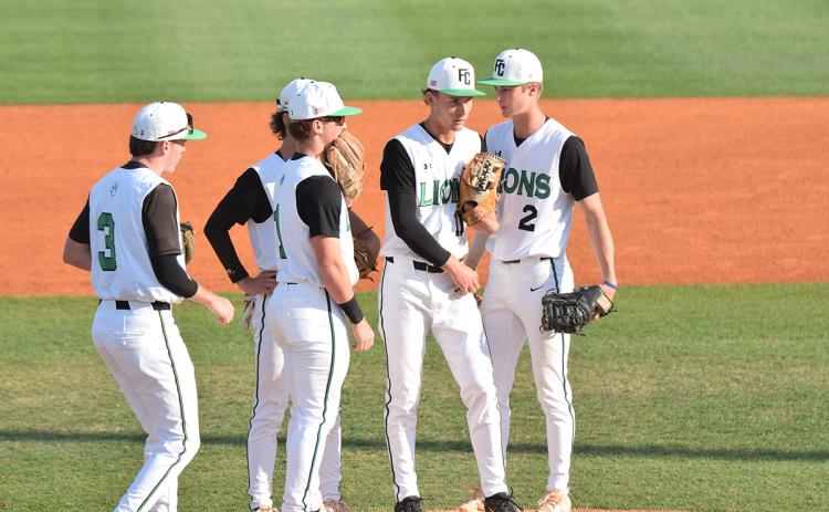 Members of the Franklin County Lion infield gather around pitcher Caden Cawthon during Wednesday's Region 8AA game against Stephens County in Carnesville. (Photo by Shane Scoggins)
