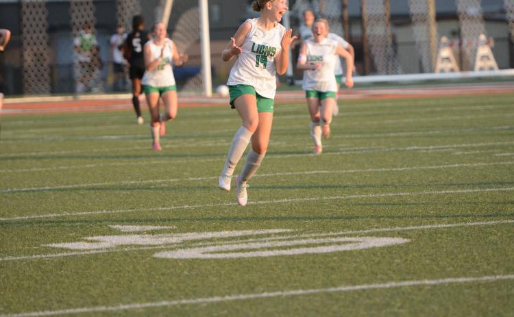 Mckenna Roberts (left photo) celebrates after her goal Friday against the Hart County Lady Bulldogs in Hartwell.