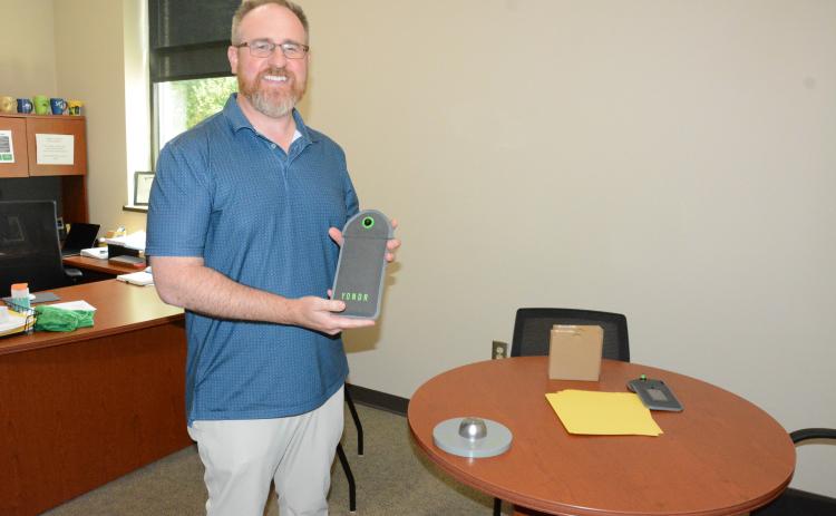Franklin County High School Principal Curtis Chitwood shows off the school’s YONDR Pouch system to prevent the use of electronic devices during the school day. (Photo by Charlie Eavenson)
