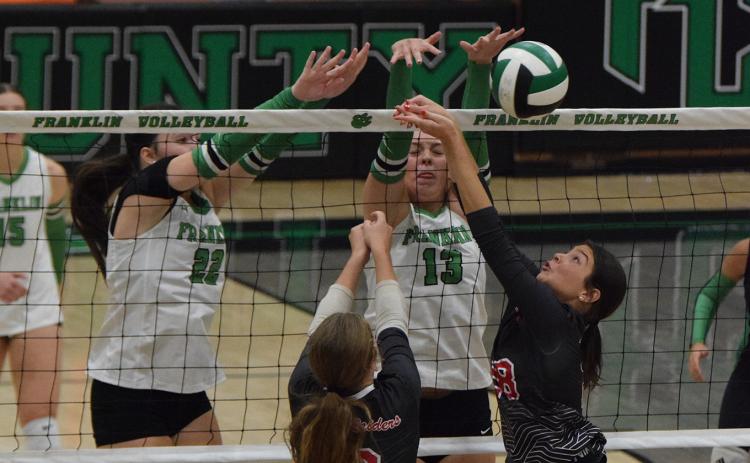 Lady Lions Avery Burton (left) and Sydney Carson (right) stuff a Madison County shot Thursday in non-region action in The Lion’s Den. (Photos by Shane Scoggins)