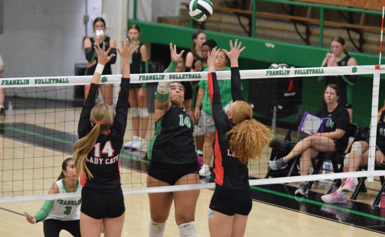 Kallie Thrift hits a ball over the net in a game earlier this year. Thrift has helped lead the team to a winning record for the season after a slow start.
