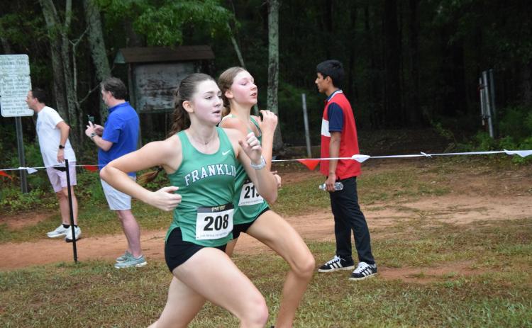 Franklin County Lady Lions Savannah Jackson and Reese Smith race each other to the finish line Saturday at the North Oconee Titans Invitational in Bogart. (Photo by Shane Scoggins)