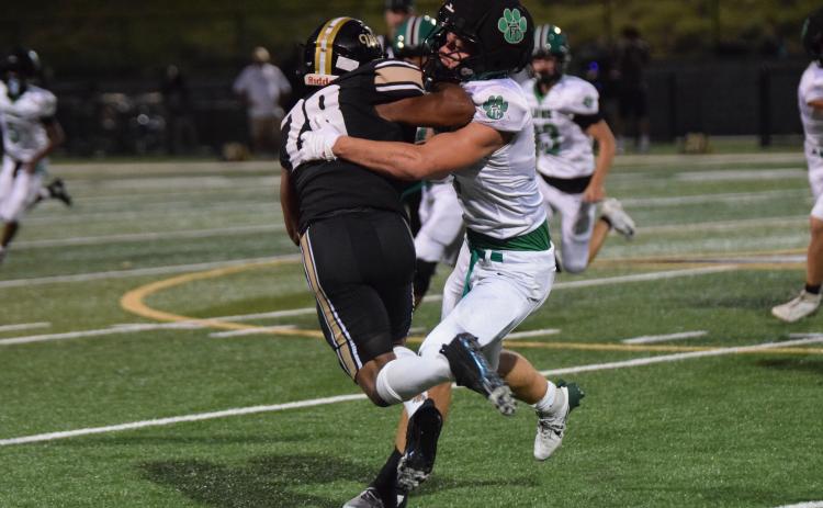 Elliott Harbin latches on to an East Hall ballcarrier for one of the Lion’s 23 tackles in Friday’s game, which set a new single game school record for tackles.