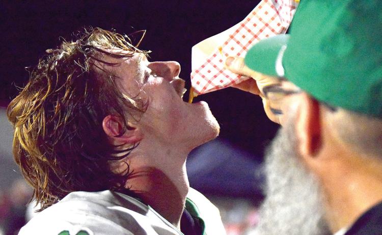 Matt London feeds mustard to Franklin County Lion football junior Jett Whitworth Friday during the Lions’ game against Madison County.