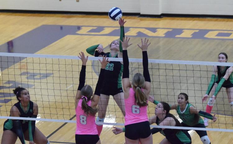 Seniors Avery Burton (No. 22), Kallie Thrift and Sydney Carson went down swinging and blocking in a state quarterfinal loss to Union County in Blairsville Saturday. (Photos by Shane Scoggins)