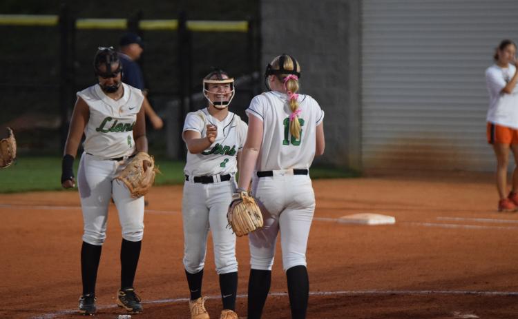 Hannah Horne laughs with Brailey Randall after Horne caught a line drive hit straight at her against Hart County Thursday.