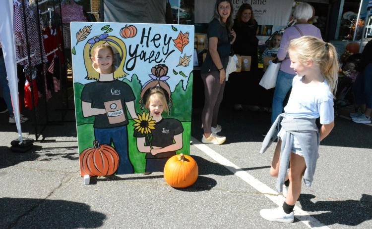 Sisters Brylee, Maggie and Kamdyn Thornton took turns having a “Hey Y’all” photo op at Saturday’s Fall in Love With Lavonia Fall Festival.
