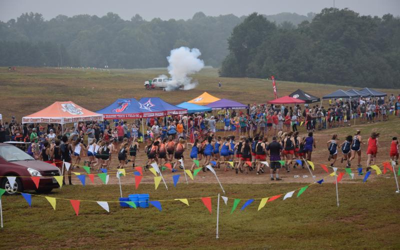 A blast from Franklin County’s touchdown canon sends runners off the start line at the Franklin County Invitational cross-country meet Saturday in Carnesville. (Photo by Scoggins)