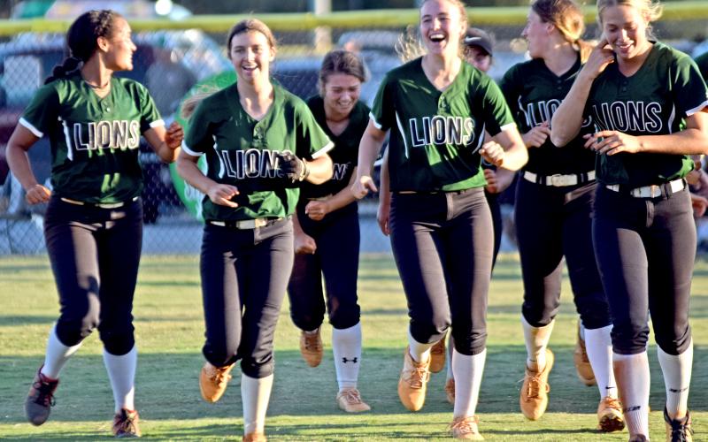 The Franklin County Lady Lions celebrate on the field Thursday after eliminating Coahulla Creek with a 14-0 win at FCHS.