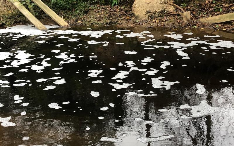 Residents along Indian Creek sent in photos of water in the stream running black Saturday due to what was found to be runoff from efforts at the GRP energy plant on Highway 198 to keep fires down in the plant’s wood pile that is being kept for fuel.