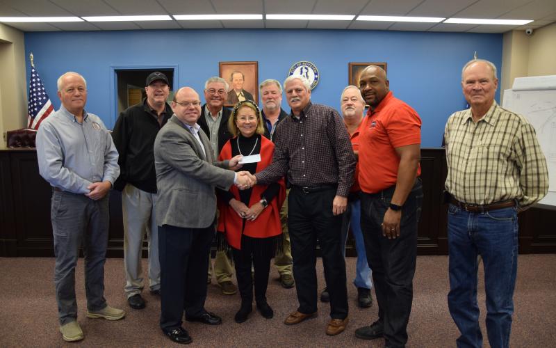 The city of Royston received a donation Thursday from Steve and Robin Williams. Pictured at the presentation of the $50,000 check are (front, from left) Royston Mayor David Jordan, Robin Williams, Steve Williams, Council members Keith Turman and Wayne Braswell, (back) City Manager Ed Andrews, Council members Matt Fields, Larry Bowen, Lee Strickland and Kenneth Roach. The money will be used to continue planning and construction of an amphitheater at the Royston Wellness and Community Park. (Photos by 