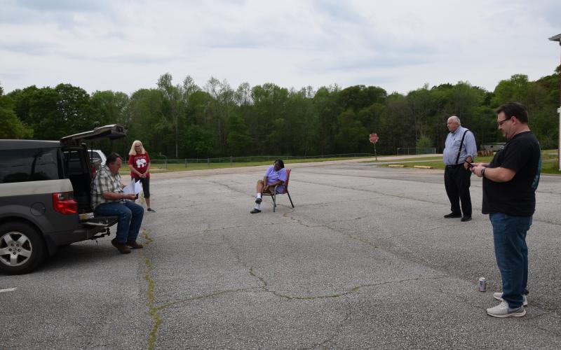 The Carnesville City Council met in the City Hall parking lot Tuesday to accept a federal grant for funding for a splash pad at the city park. (Photo by Scoggins)