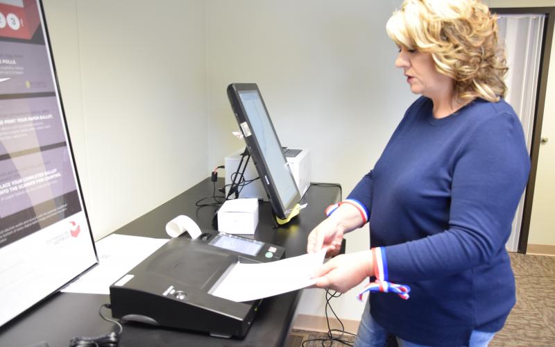Franklin County Elections Supervisor Gina Kesler demonstrates the state's new voting machine. Early voting is now open, and a special day of early voting will be held Saturday at the elections office in Carnesville.