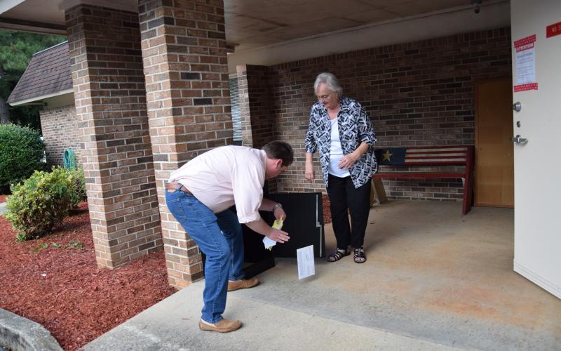 Franklin County elections workers empty a drop box of absentee ballots shortly before 7 p.m. Tuesday.