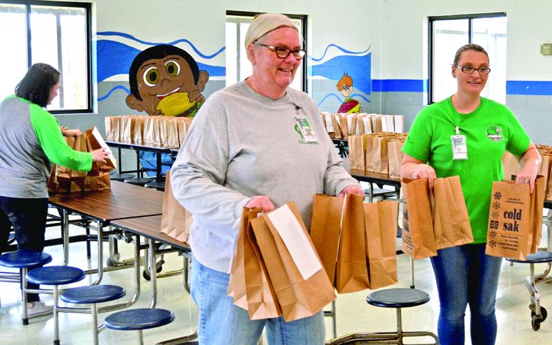 Members of the Franklin County School System’s nutrition department tote lunches after a program began in March to provide meals to students in the community. By the time the program ended June 23, the system served more than 200,000 meals.