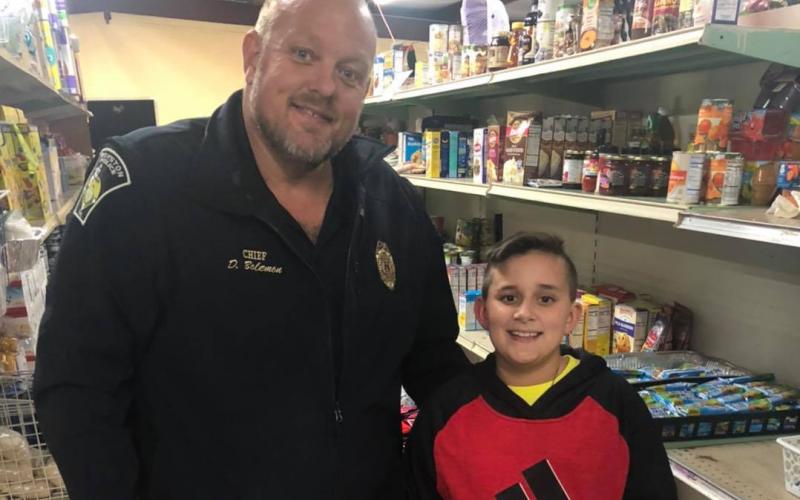 Hunter Blackmon (right), 11, a sixth grader at Franklin County Middle School, recently donated $120 to the Rainbow Pantry in Royston from money he made operating a store near Victoria Bryant State Park. The Rainbow Pantry’s Donnie Bolemon accepted the donation.