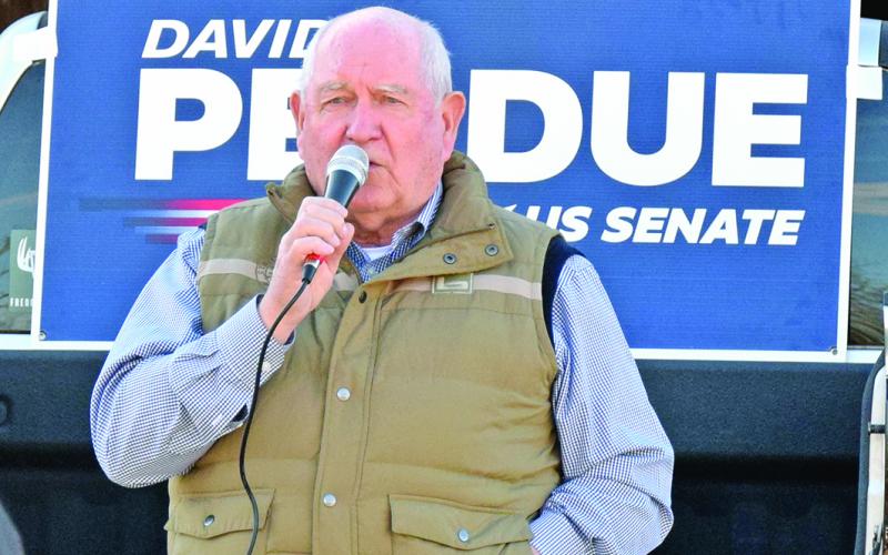 U.S. Secretary of Agriculture Sonny Perdue speaks Tuesday during a rally in Royston in support of Republican Sens. David Perdue and Kelly Loeffler. (Photo by Scoggins)