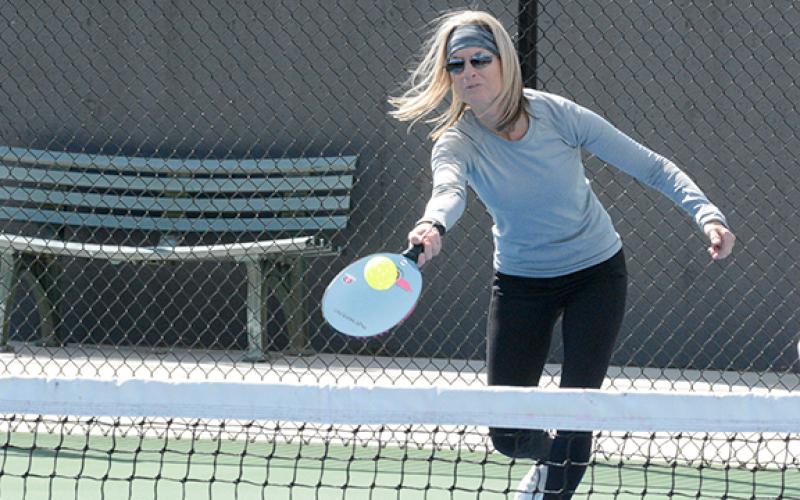 Tammy Pitt reaches for a return in her mixed doubles match at the Bell Family YMCA on Friday, April 8, 2022. Pickleball facilities are a possibility for Lavonia if the SPLOST is continued. (Photo by The Hartwell Sun)