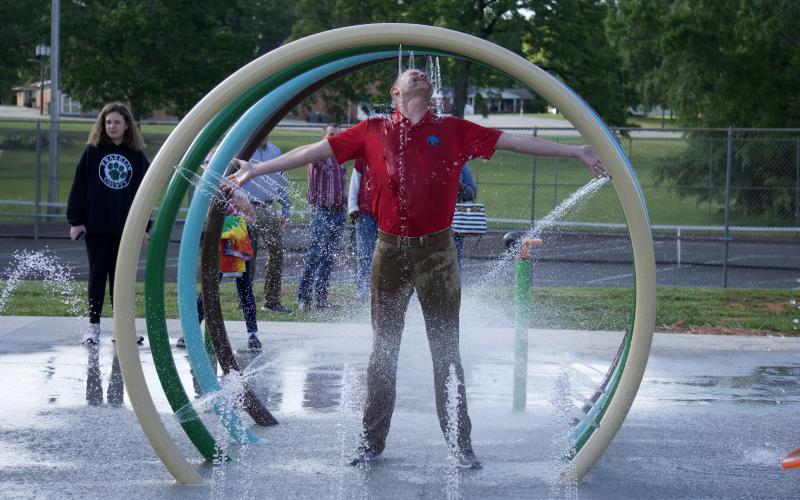 Lavonia City Council member Andrew Murphy takes in the full experience of the city’s new splash pad during a demonstration following the council’s meeting Monday night.