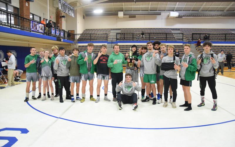 The Franklin County Lion wrestling team celebrates back-to-back Area 8AAA Duals championships after winning the 2024 title Saturday at Oconee County. The team will wrestle in the state tournament Jan. 19-20.