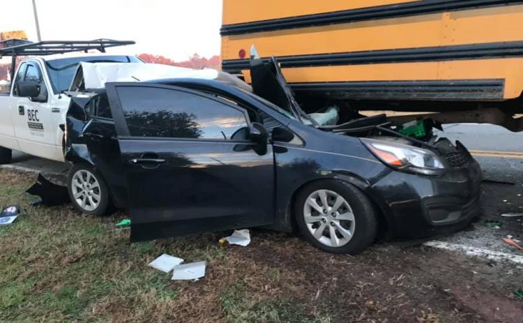 The driver of a Kia Rio was injured Thursday when his car was rear-ended and pushed into and under a school bus that was stopped to pick up a student. (Photo courtesy of Jordan Britton)