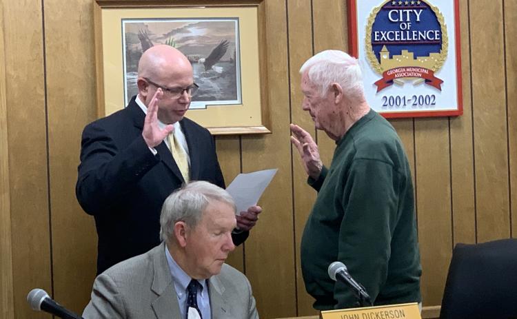 Lavonia Mayor Ralph Owens (right) swears in new Councilmember Michael Schulman (left) during Owens’ final meeting as mayor. City Attorney John Dickerson looks on.