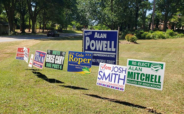 Campaign signs planted beside the road show many candidates seeking the support of voters in the May 24 primary.