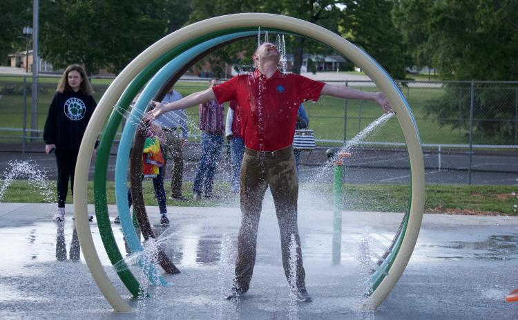 Lavonia City Council member Andrew Murphy takes in the full experience of the city’s new splash pad during a demonstration following the council’s meeting Monday night.