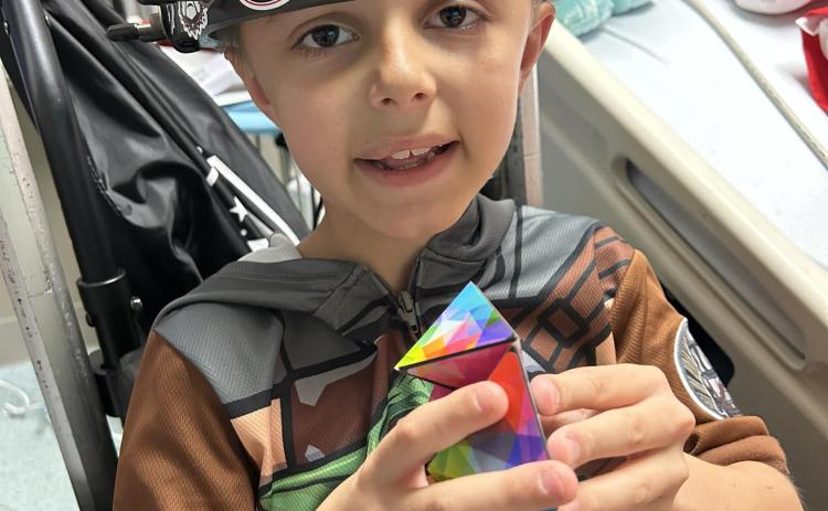 Alex Adams, a young scoliosis patient, underwent a procedure at Childrens Hospital of Atlanta using a halo device to help his condition.