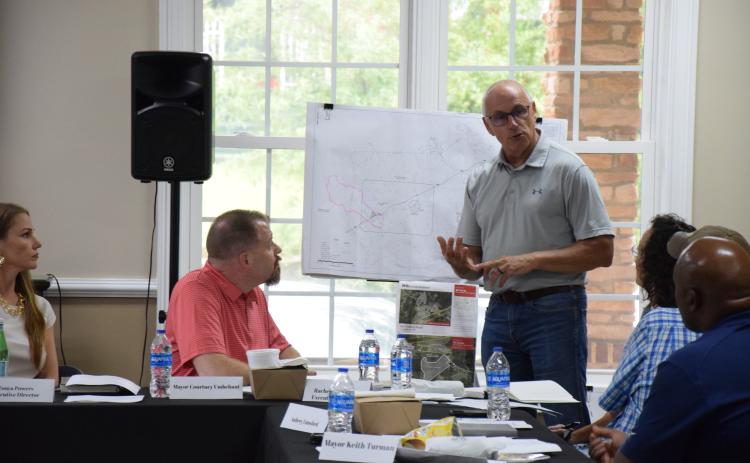 County Engineer John Phillips presents options last week to the IBA to expand sewer service in the area of Exit 160 on I-85. (Photo by Scoggins)