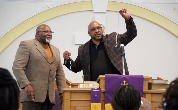 Royston Mayor Keith Turman (right) and Pastor Samuel White (left) demonstrate the strength of a chain versus a lone string in encouraging community members to unite during Monday’s annual Martin Luther King Jr. program.