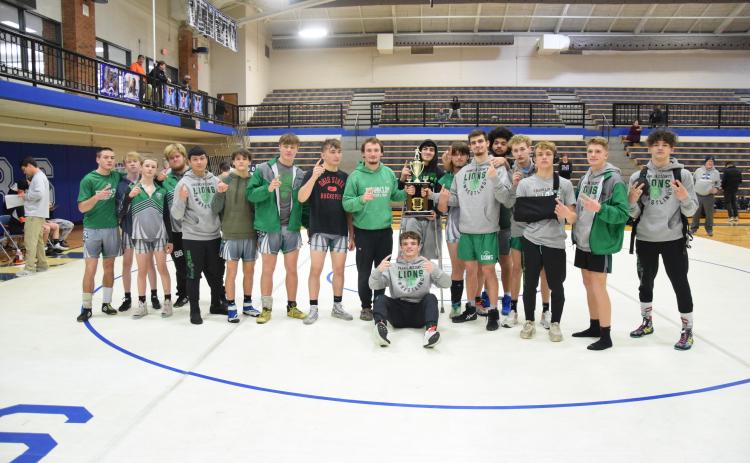 The Franklin County Lion wrestling team celebrates back-to-back Area 8AAA Duals championships after winning the 2024 title Saturday at Oconee County. The team will wrestle in the state tournament Jan. 19-20.