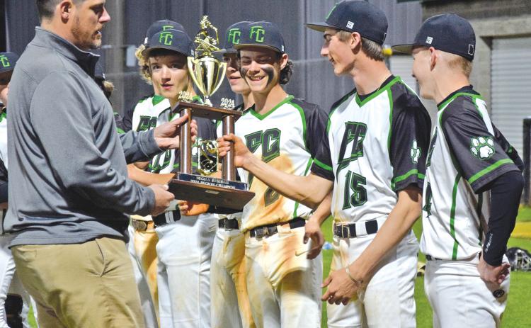 Franklin County Athletic Director Clay Moore presents the NEGIAA region baseball championship trophy to the Franklin County Middle School Cubs after FCMS swept Stephens County Monday for the region title. (Photo by Scoggins)